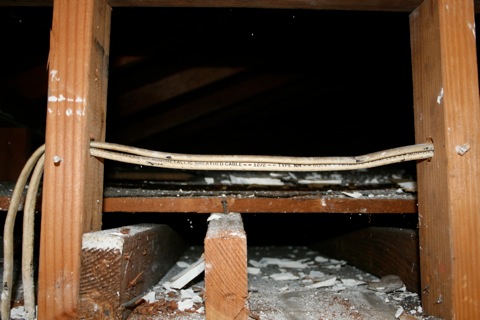 Old wires in the space above the future closet door