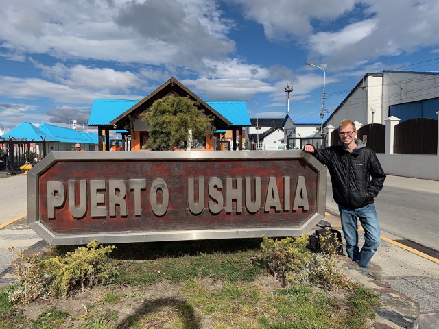 James at the Puero Ushuaia sign