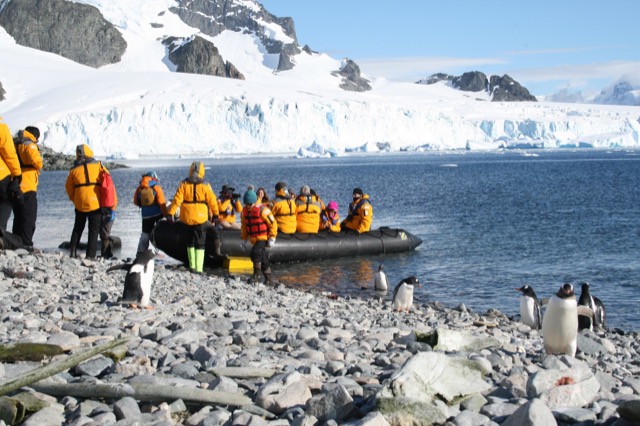 Loading the Zodiac while the penguins supervise