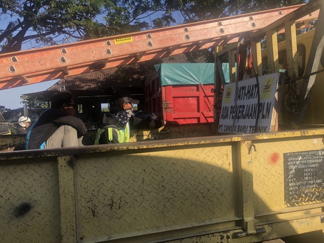 Guys in the back of a dump truck