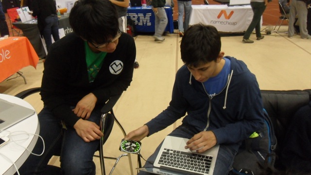 David Lui helping a student with his BoilerMake Badge