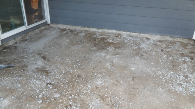 After: Cleared concrete pad under overhang