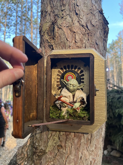 Yoda hiding in a box on a tree