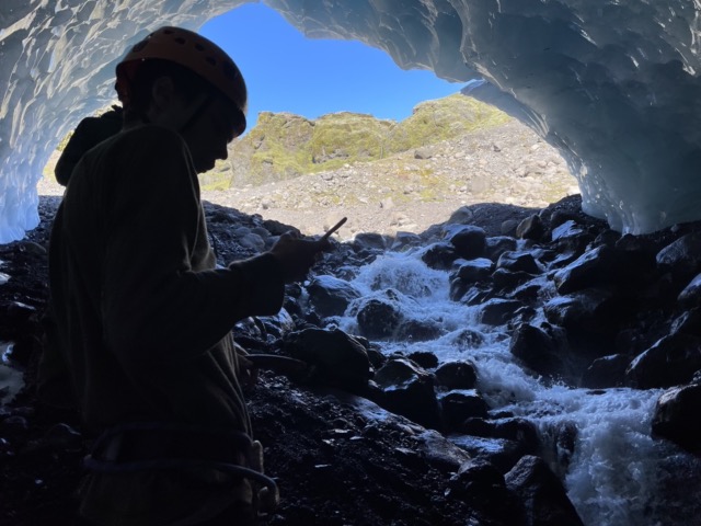 Harris in the ice cave, checking his phone