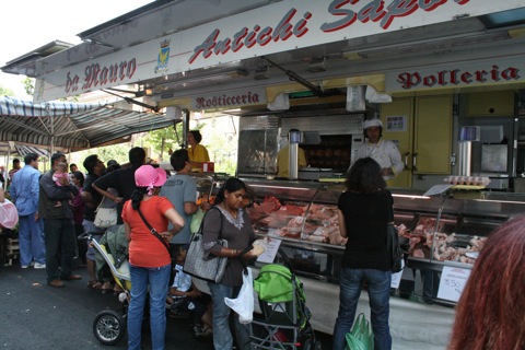 Meat cart at the outdoor market with rotisserie chicken