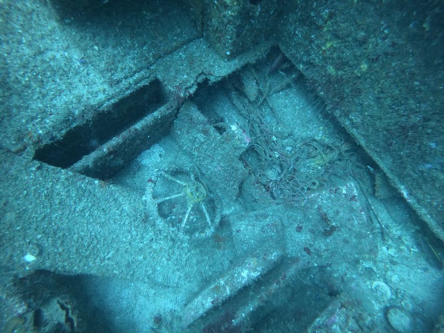 Looking down into the sunken ship with the steering wheel