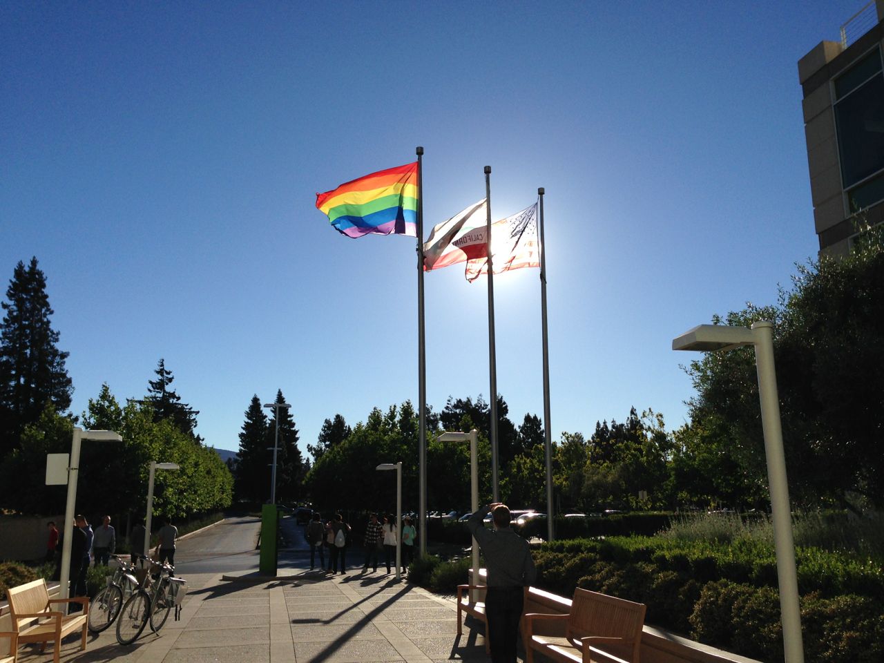 Rainbow flag at the Apple Campus, backlit