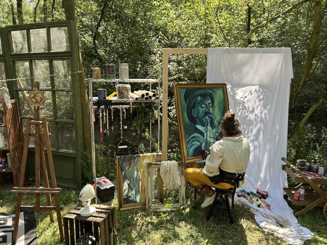 Walking towards the festival, they had an artist painting in the woods