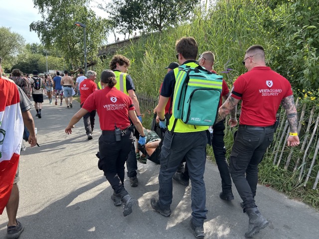 Medics carrying someone through the crowd