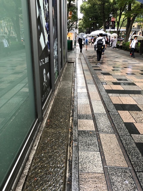 Really cool waterfall / gutter next to the sidewalk